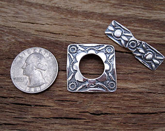 VDI Jewelry Findings Large Sterling Silver Southwest Style Toggle Clasp Next to a Quarter