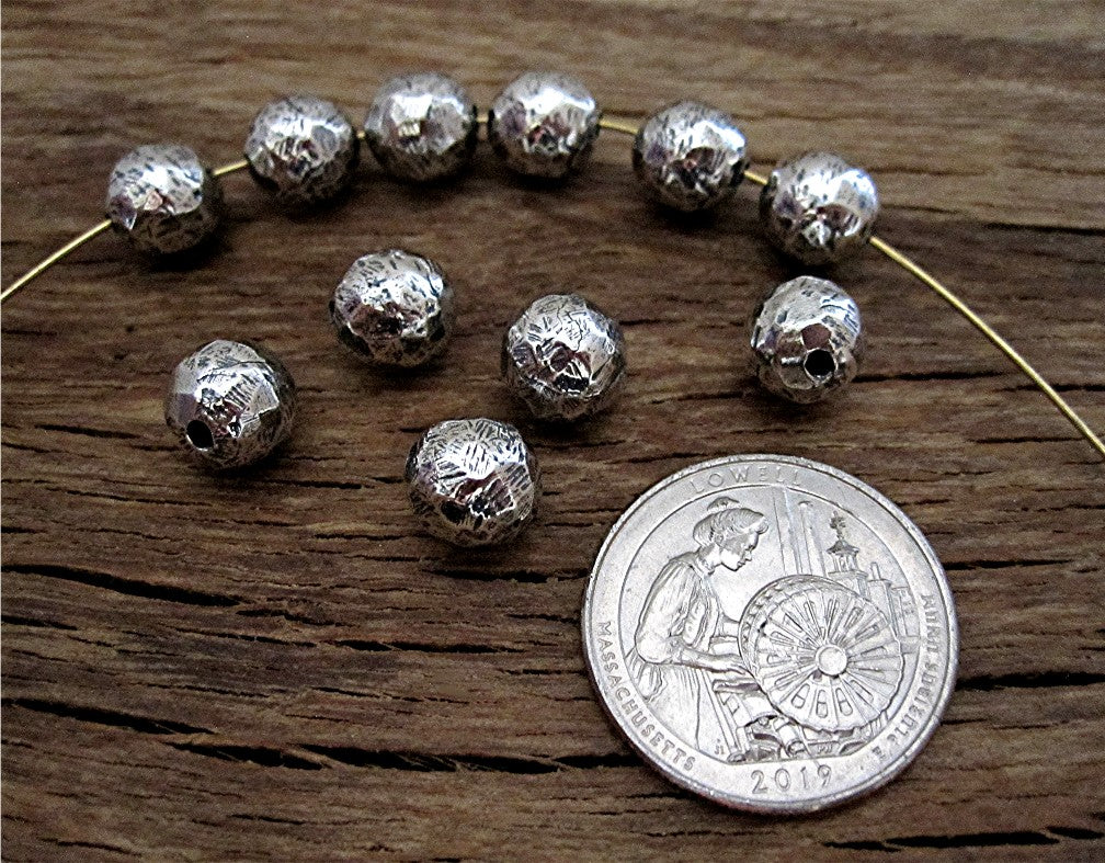 Sterling Silver 8mm Rustic Bead next to a Quarter