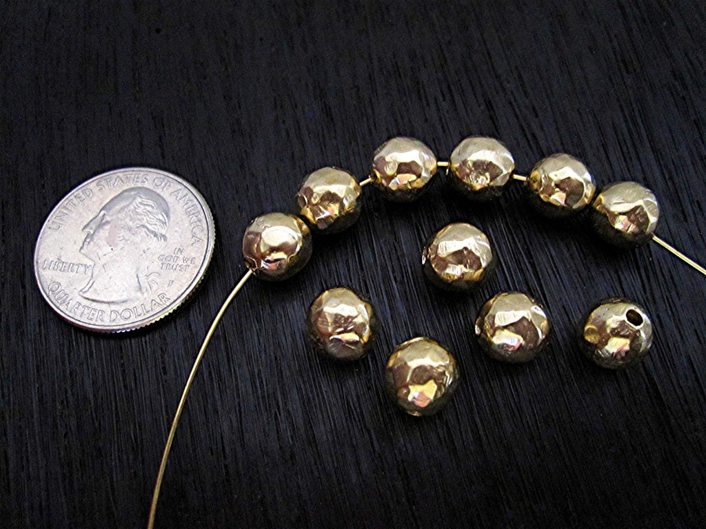 Gold Bronze Rustic 8mm Round Spacer Beads next to a quarter