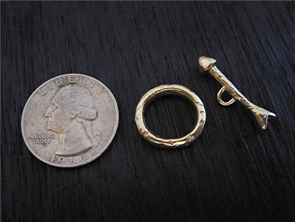 VDI Jewelry Findings Rustic Gold Bronze Arrow Toggle Clasp Next to a Quarter