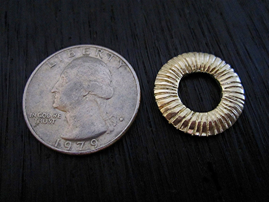 Large Gold Bronze Line Disc Shaped Jewelry Link next to a Quarter