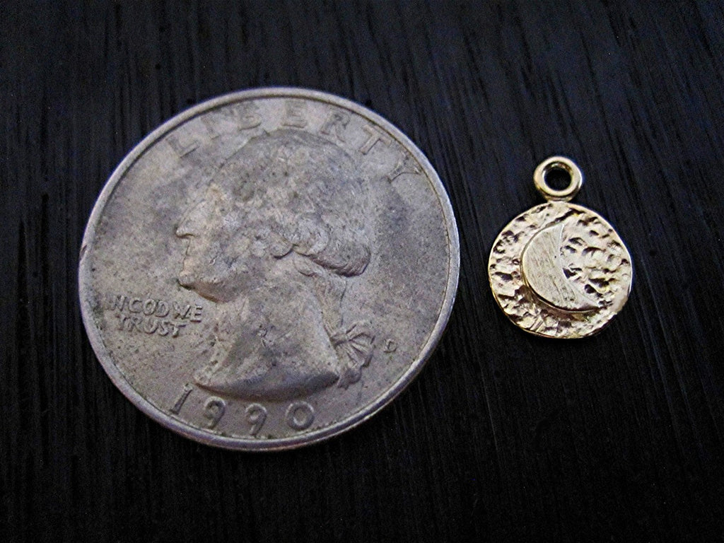 Small Gold Bronze Moon Charms Next to a Quarter