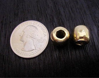 VDI Jewelry Findings Large Smooth Gold Bronze Bead and Spacer Next to a Quarter