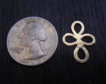 Gold Bronze Flower Charm and Link next to a quarter