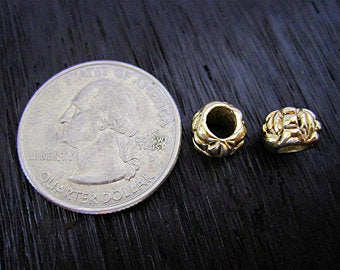 VDI Jewelry Findings Gold Bronze Artisan Round Jewelry Beads next to a Quarter