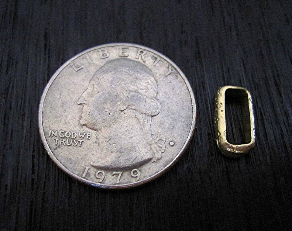 Gold Bronze Textured Rectangular Link Next to a Quarter