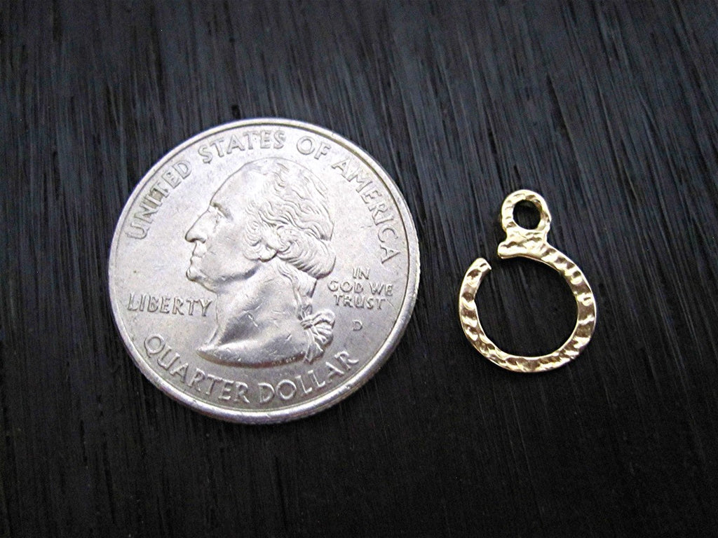 Small Gold Bronze Textured Jewelry Bail next to Quarter