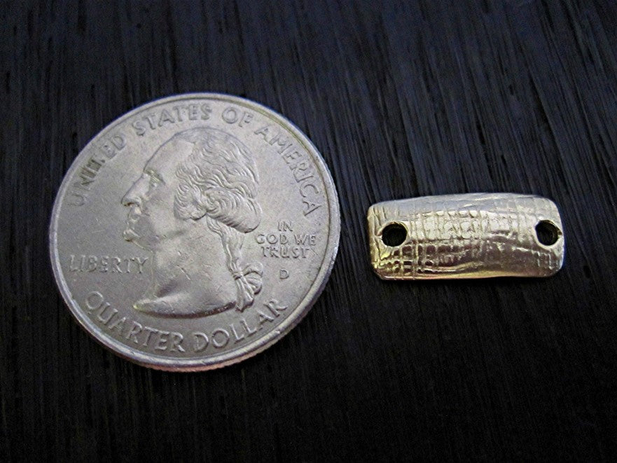 Gold Bronze Rectangular Jewelry Link next to a quarter