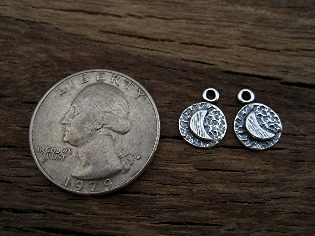 Sterling Silver Artisan Half Moon Charms next to a Quarter