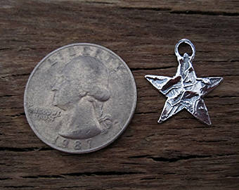 Rustic Textured Sterling Silver Star Charm next to a Quarter